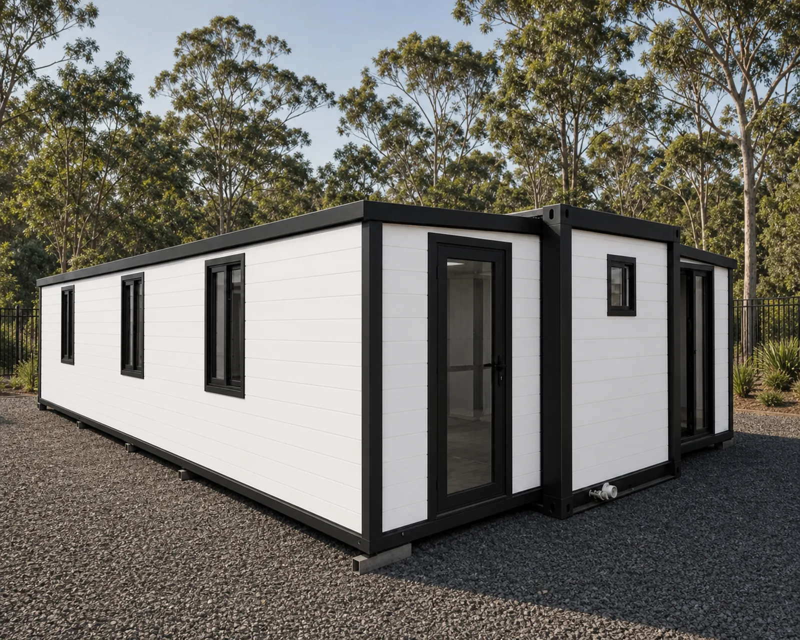 The 9 m expandable home from the closed end, weatherboard cladding and narrow windows with the fold out wings shut against the body