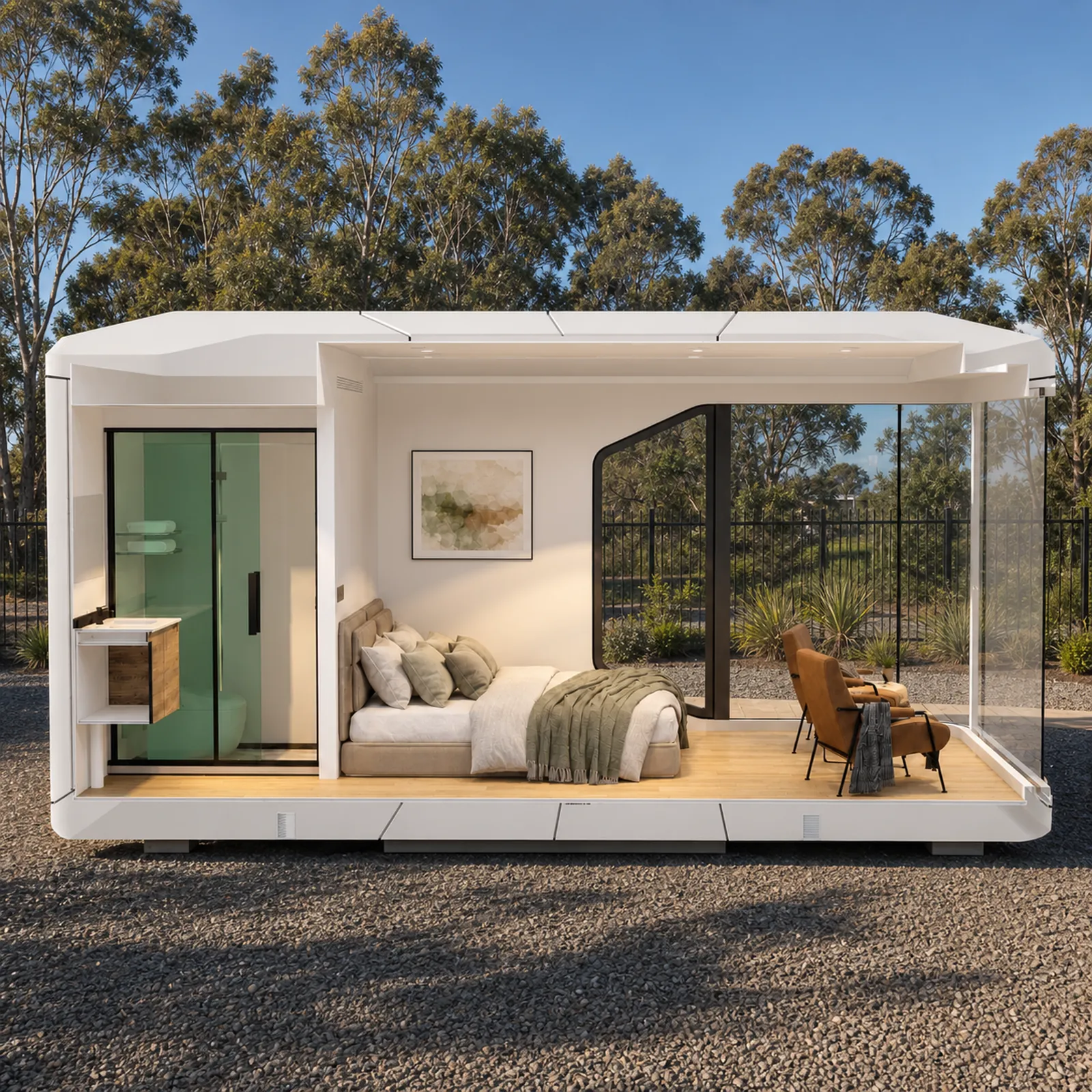 Cutaway of the capsule studio, green tiled shower at the left, a double bed against the back wall and two leather chairs by the glazed opening
