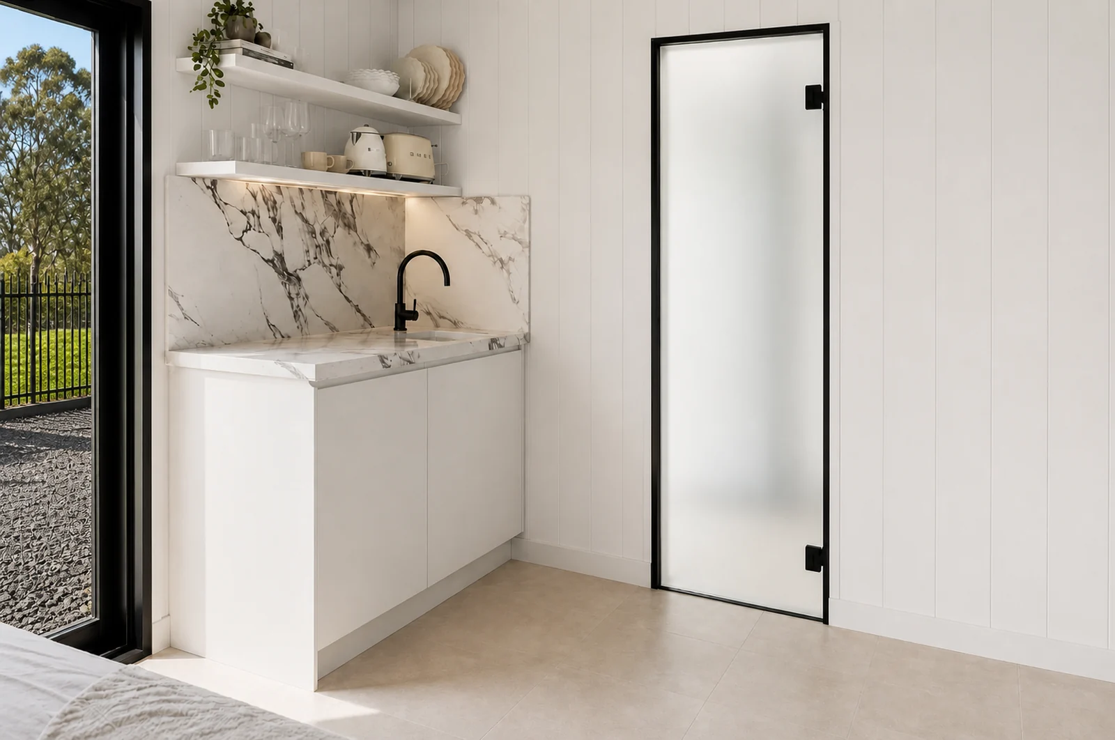 Kitchenette in the mirror house, marble look splashback and benchtop with a black mixer, open shelving and a frosted glass door to the bathroom