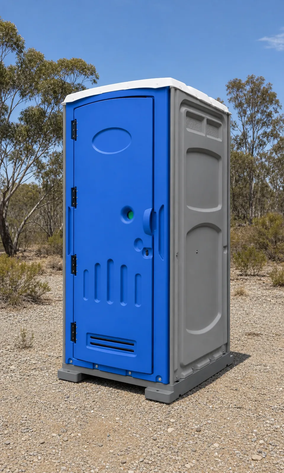 Blue and grey moulded plastic portable toilet standing on its own pallet base in dry scrub