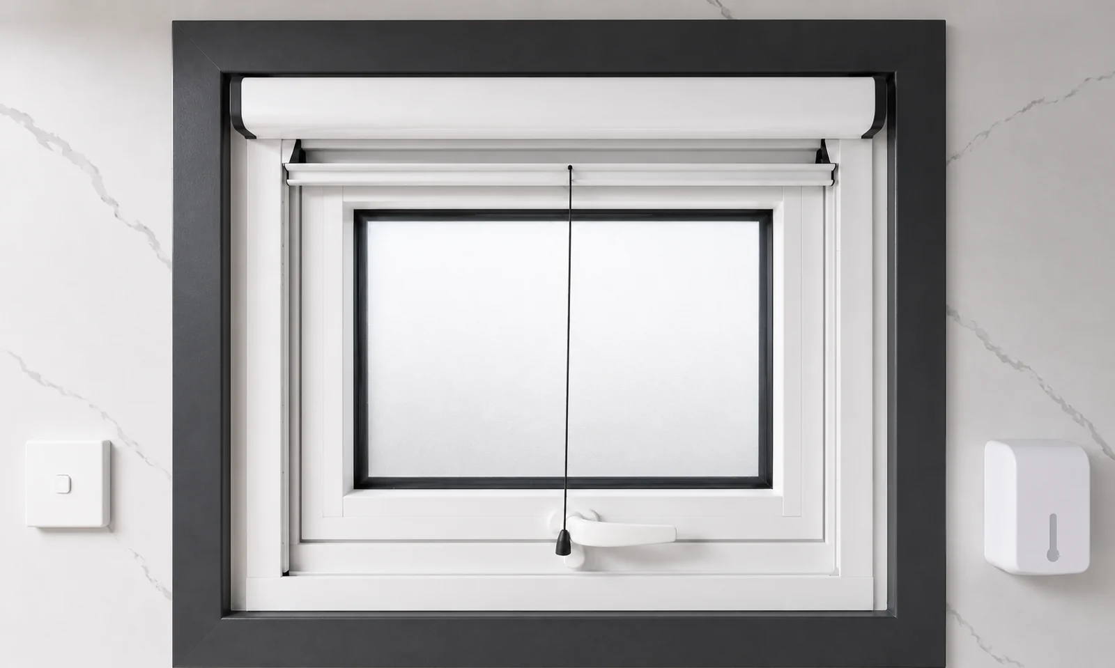 Awning window in the portable bathroom with a roller blind above, a light switch on one side and a soap dispenser on the other