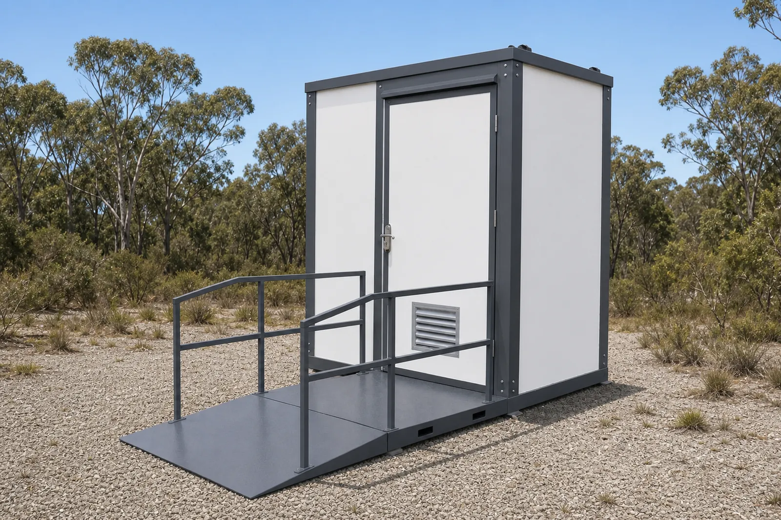 Accessible toilet cabin with a fixed steel ramp and handrail leading up to a glazed door, and a louvre vent in the side, in dry bush