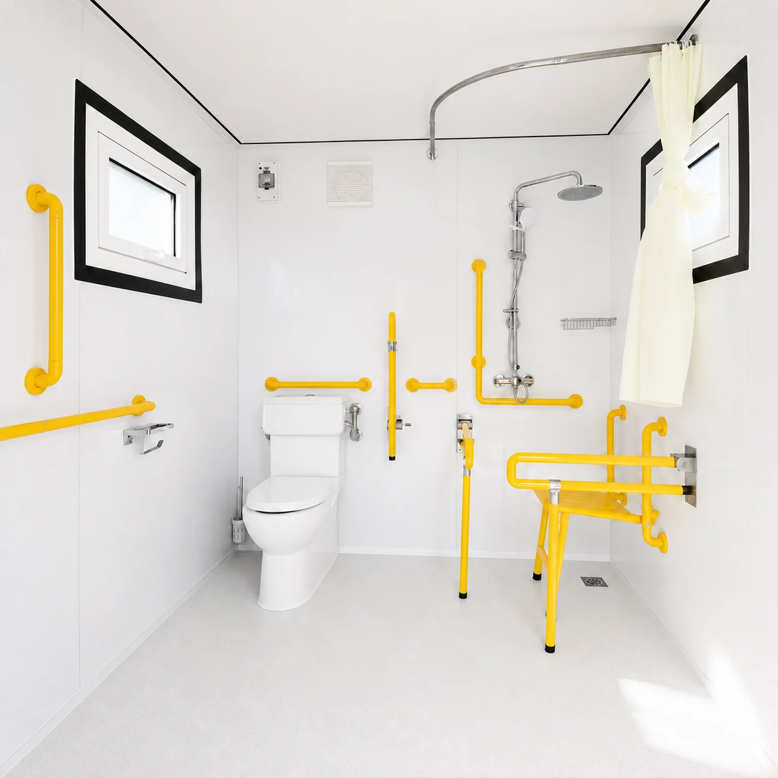 Inside an accessible shower and toilet unit, with yellow grab rails around the pan, a fold down shower seat, a rail shower and a curtain