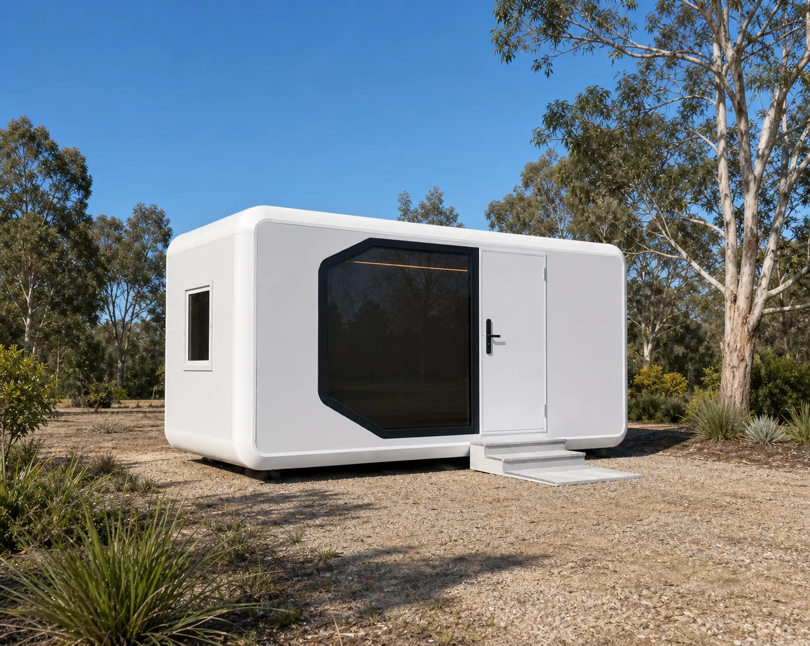 The rounded capsule on bare ground under gum trees, showing the small side window, the panoramic window and the entry ramp
