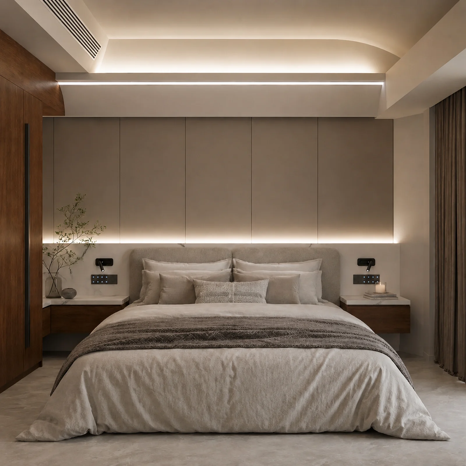 Bedroom in the 9.5 m capsule, double bed against an upholstered panelled wall with concealed lighting and timber joinery either side