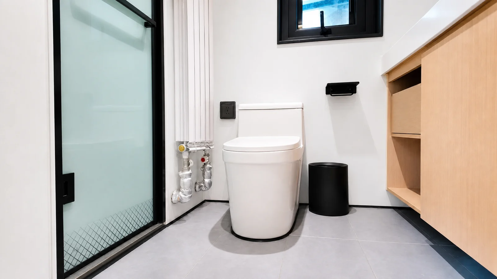 Toilet in the timber clad capsule beside a frosted glass shower screen, with a timber vanity and a small window above