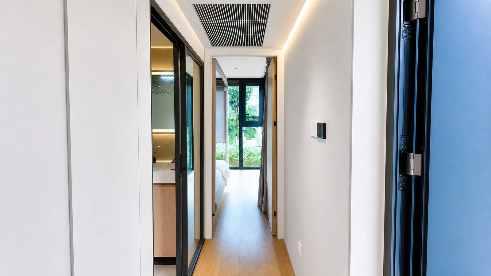 Corridor in the 9.5 m timber clad capsule, bathroom doorway on the left and the bed visible at the glazed far end