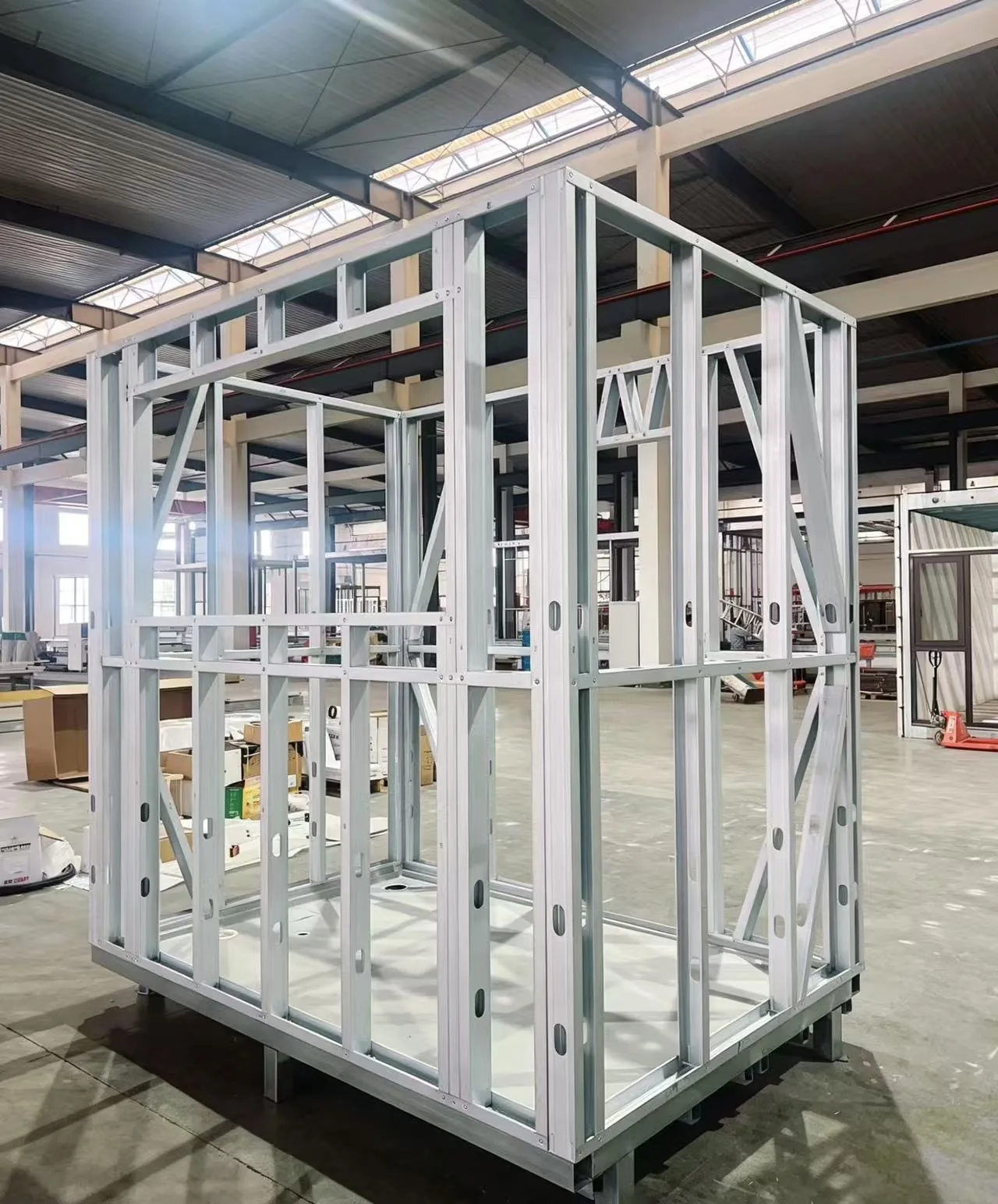 Galvanised steel frame of a bathroom pod standing on the factory floor before the wall panels and services are installed
